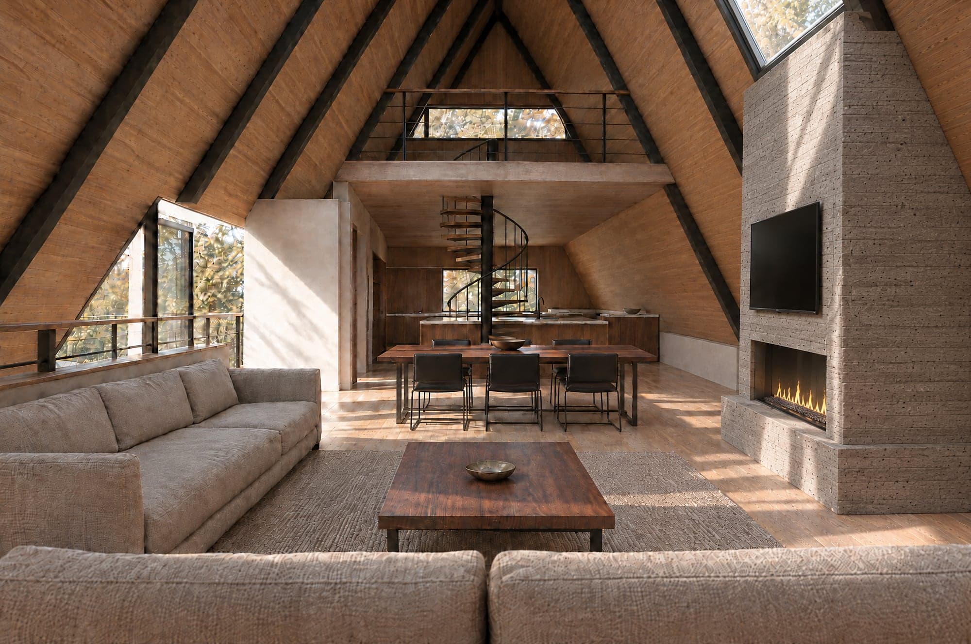 Photographic image of the Version 1 great room seen from the glass gable: the back of a linen sofa in the foreground, a walnut coffee table on a jute rug, a second sofa along the left knee wall, a walnut dining table running across the room with black leather chairs on both long sides, a black spiral stair with its handrail rising to the loft, the dark-oak kitchen with a stone island under the loft, a wide window in the loft's north wall above its rail, the roof planes lined in wood with black steel beams, a tall board-formed concrete fireplace with a linear firebox and a television on the right wall, facing the long sofa and rising directly beneath a skylight high in the right roof plane, and the deck door on the left, afternoon light across the oak floor